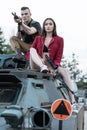 Shooting men sitting on the tank with a women near him. Royalty Free Stock Photo