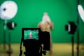 Shooting the movie on a green screen. The chroma key. Studio videography. Actor in theatrical costume