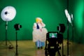 Shooting the movie on a green screen. The chroma key. Studio videography. Actress in theatrical costume