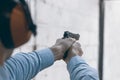 Shooting with a pistol. Man aiming pistol in shooting range. Royalty Free Stock Photo