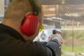 Shooting with a pistol. Man Firing pistol in shooting range. Royalty Free Stock Photo