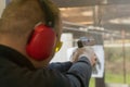 Shooting with a pistol. Man Firing pistol in shooting range. Royalty Free Stock Photo