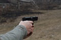 Shooting from a pistol. Reloading the gun. The man is aiming at the target. Shooting range. Man firing usp pistol at target in ind Royalty Free Stock Photo