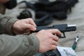 Shooting from a pistol. Reloading the gun. The man is aiming at the target. Shooting range. Man firing usp pistol at target in ind Royalty Free Stock Photo