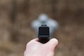 Shooting from a pistol. Reloading the gun. The man is aiming at the target. Shooting range. Man firing usp pistol at target in ind Royalty Free Stock Photo