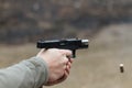 Shooting from a pistol. Reloading the gun. The man is aiming at the target. Shooting range. Man firing usp pistol at target in out Royalty Free Stock Photo