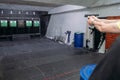 Shooting range. Rear view of men shooting with gun in shooting range. Royalty Free Stock Photo