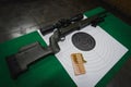 Shooting at the shooting range for accuracy. Sniper rifle, cartridges and shooting target Royalty Free Stock Photo