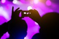 Shooting on smartphone festival concert. Blurred music stage bokeh background for design. Royalty Free Stock Photo