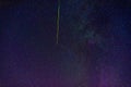 shooting star meteorite comet on background of blue dark starry sky with galaxies and nebulae Royalty Free Stock Photo