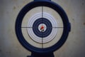 Sniper (marksman) hits almost bull\'s eye. Scope and shooting target (shot holes in it). Royalty Free Stock Photo