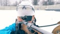 Shooting zone with a female biathlete aiming while being in it