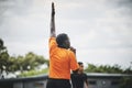 He shoots and scores. a referee blowing his whistle while lifting his hand up in the middle of a rugby match on a field