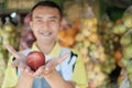 The shop assistant hands over the apples with two hands Royalty Free Stock Photo