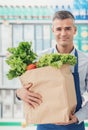 Shop assistant holding a grocery bag Royalty Free Stock Photo