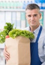 Shop assistant holding a grocery bag Royalty Free Stock Photo