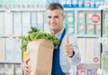 Shop assistant holding a grocery bag Royalty Free Stock Photo