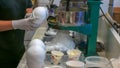 A shop assistant makes hawaiian shave ice Royalty Free Stock Photo