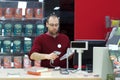 Shop assistant male scanning a book Royalty Free Stock Photo