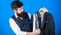 Shop assistant or personal stylist service. Matching necktie with outfit. Man bearded hipster hold neckties and formal