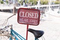 Shop bar sign saying sorry we are closed on bike parked front restaurant in Ile de Re France Royalty Free Stock Photo