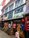 A shop below a building with ancient wooden galleries