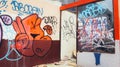 A shop building that is damaged and full of graffiti
