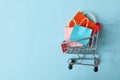 Shop cart with paper bags on blue background Royalty Free Stock Photo