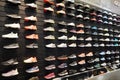 Shop display of a lot of Sports shoes on a wall. A view of a wall of shoes inside the store. Modern new stylish sneakers running Royalty Free Stock Photo