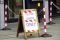 Shop entrance sign and barrier cones with chain