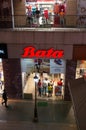 Shop exterior of a bata store in a busy shopping mall at night