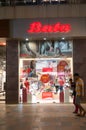 Shop exterior of a bata store in a busy shopping mall at night