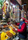 A shop keeper hangs a bunch of garlic bulbs in the Spice Bazaar in Istanbul in Turkey.