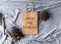 Support Small Businesses text on a plain brown paper bag flat lay