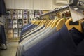 Shop of men`s clothing. On the hanger in a row, men`s suits are hung. Royalty Free Stock Photo