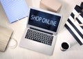 Shop online concept. Laptop screen,coffee and shopping bags and box top view. Internet purchase Royalty Free Stock Photo