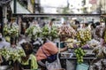 A shop selling citrus fruits in plastic bags is hung on a cart in the streets of Bangkok