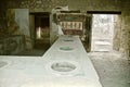 Shop selling food in the central street of Pompeii. Naples