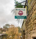Secondhand book shop sign on a traditional stone wall