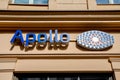Shop sign of an optician named Apollo in Potsdam on a house wall in blue with logo