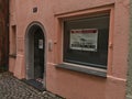 Shop space in old building with pink facade in center offered for rental by real estate agent Engel and VÃÂ¶lkers (sign).