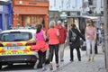 Shop Street, Galway, Ireland june 2017 , Man and dougther joggin near to a Garda car.