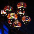 Shop with traditional mosaic multi colored turkish lamps or lanterns. Square photo. Popular souvenir from Turkey