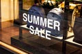 Shop window of the bags store with big white words summer sale in the shopping mall. Royalty Free Stock Photo