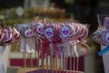 A shop window with colorful lollipops on a stick.