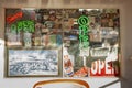 Shop window cover with vintage sales stickers and advertisements and photo of group of bikers outside with neon signs Royalty Free Stock Photo