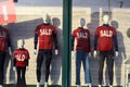 Shop window with mannequins wearing red shirts