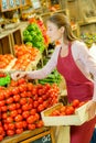 Shop worker carrying crate tomatoes