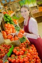 Shop worker carrying crate tomatoes