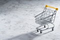Shopaholic. Buyer. Shopping concept. Close-up. An isolated trolley and shopping basket on a white background bisected